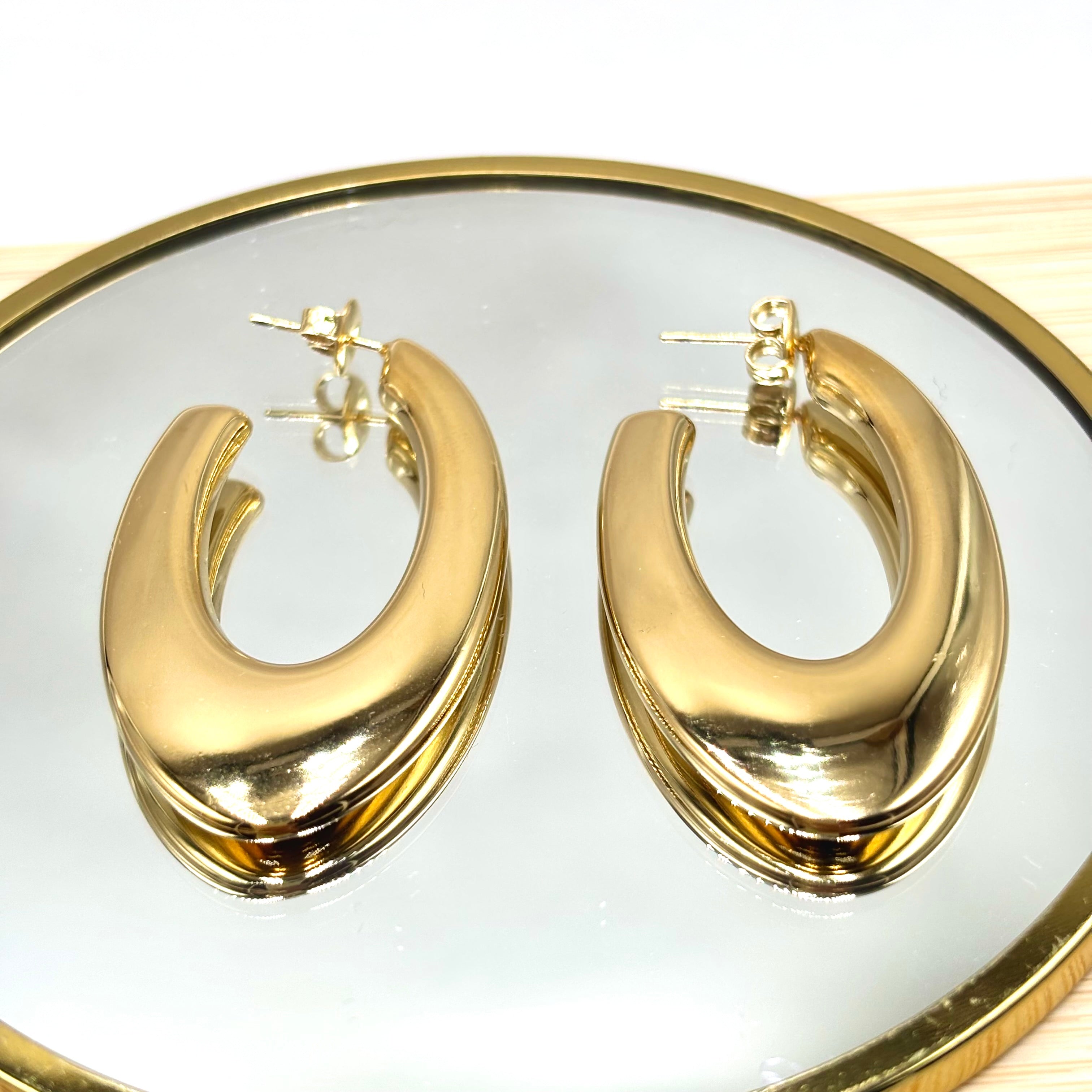 Boucles d'oreilles créoles ovales effet plat acier inoxydable doré sur miroir