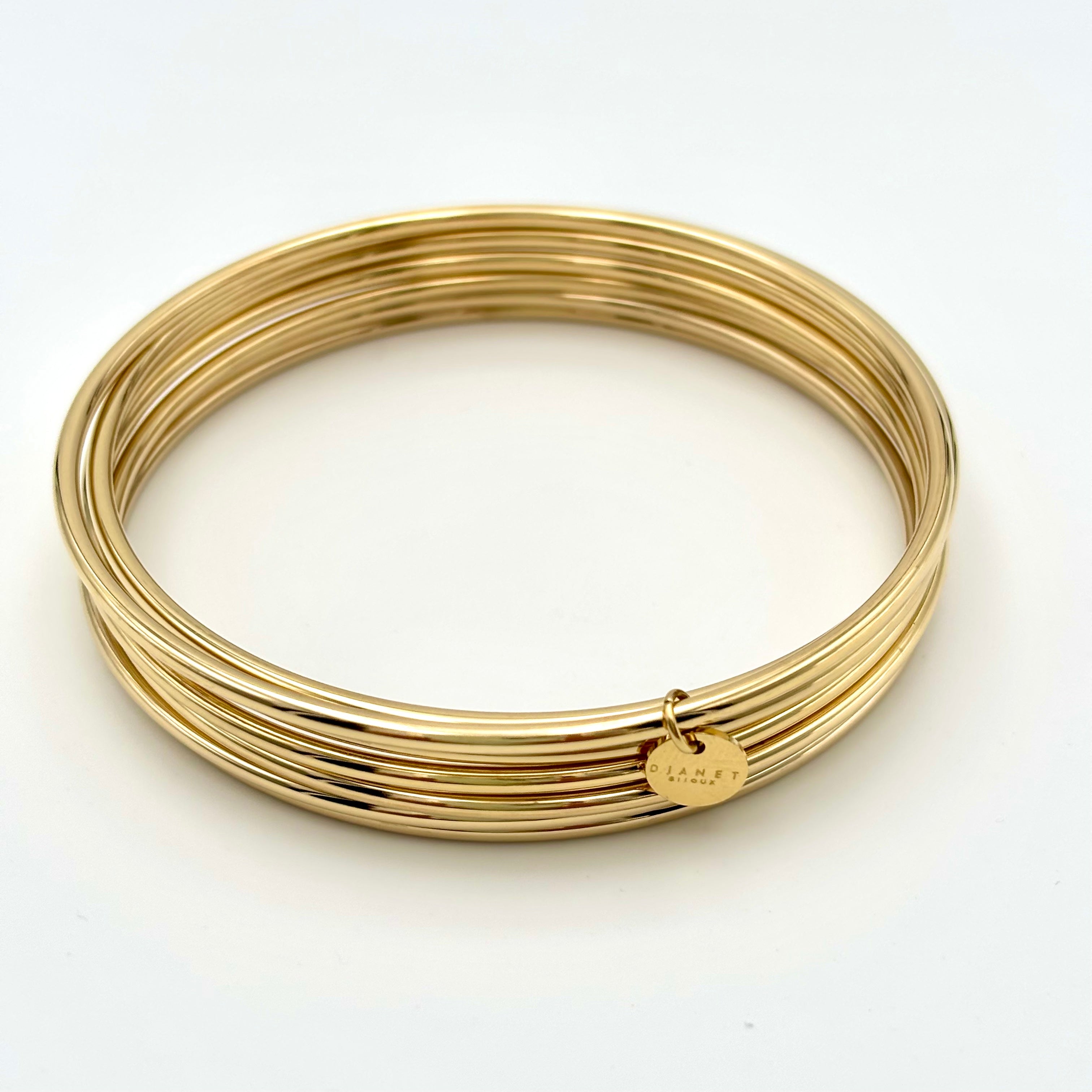 Bracelet semainier Djanette lot de 7 joncs en acier inoxydable doré