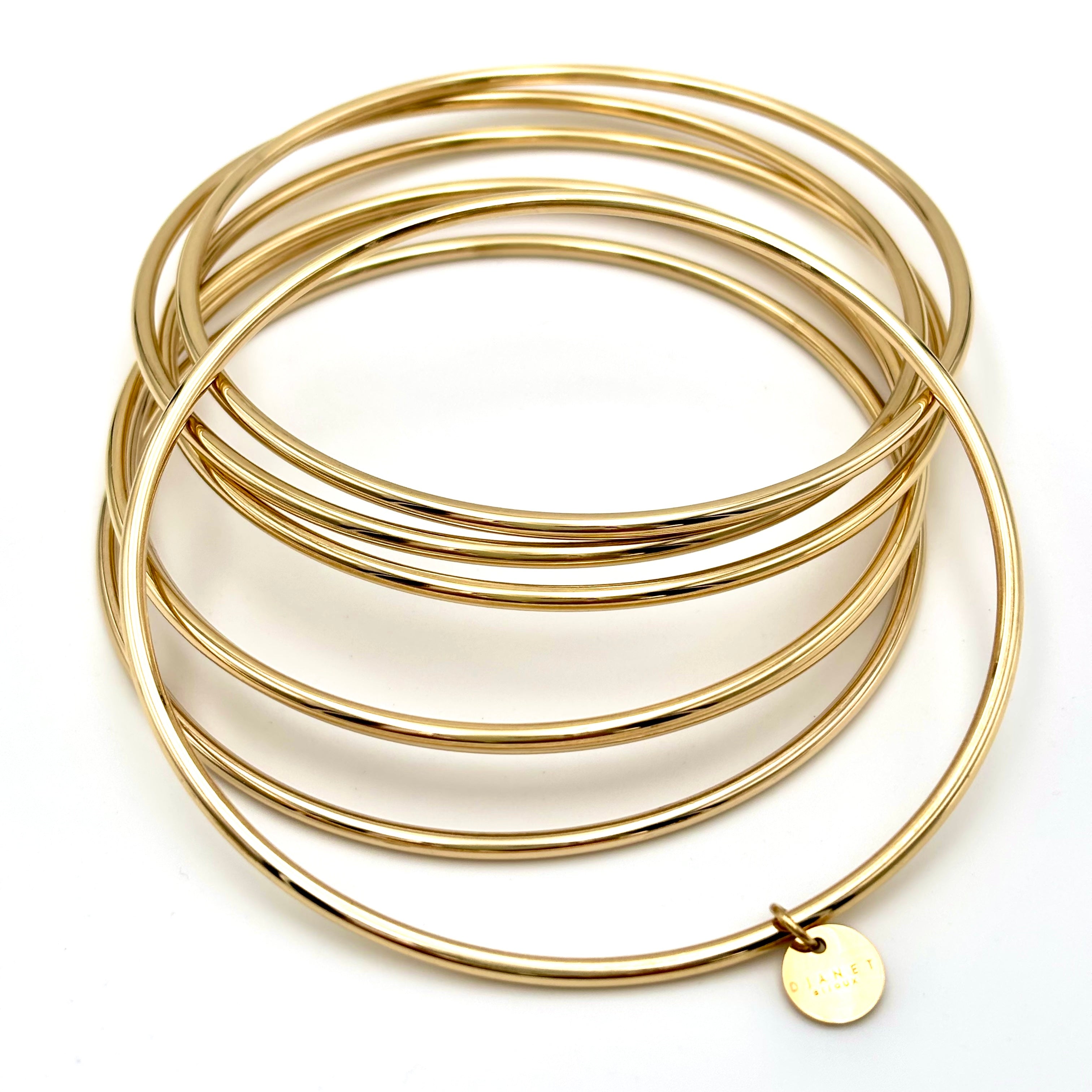 Bracelet semainier 7 joncs en acier inoxydable doré à l'or fin djanette