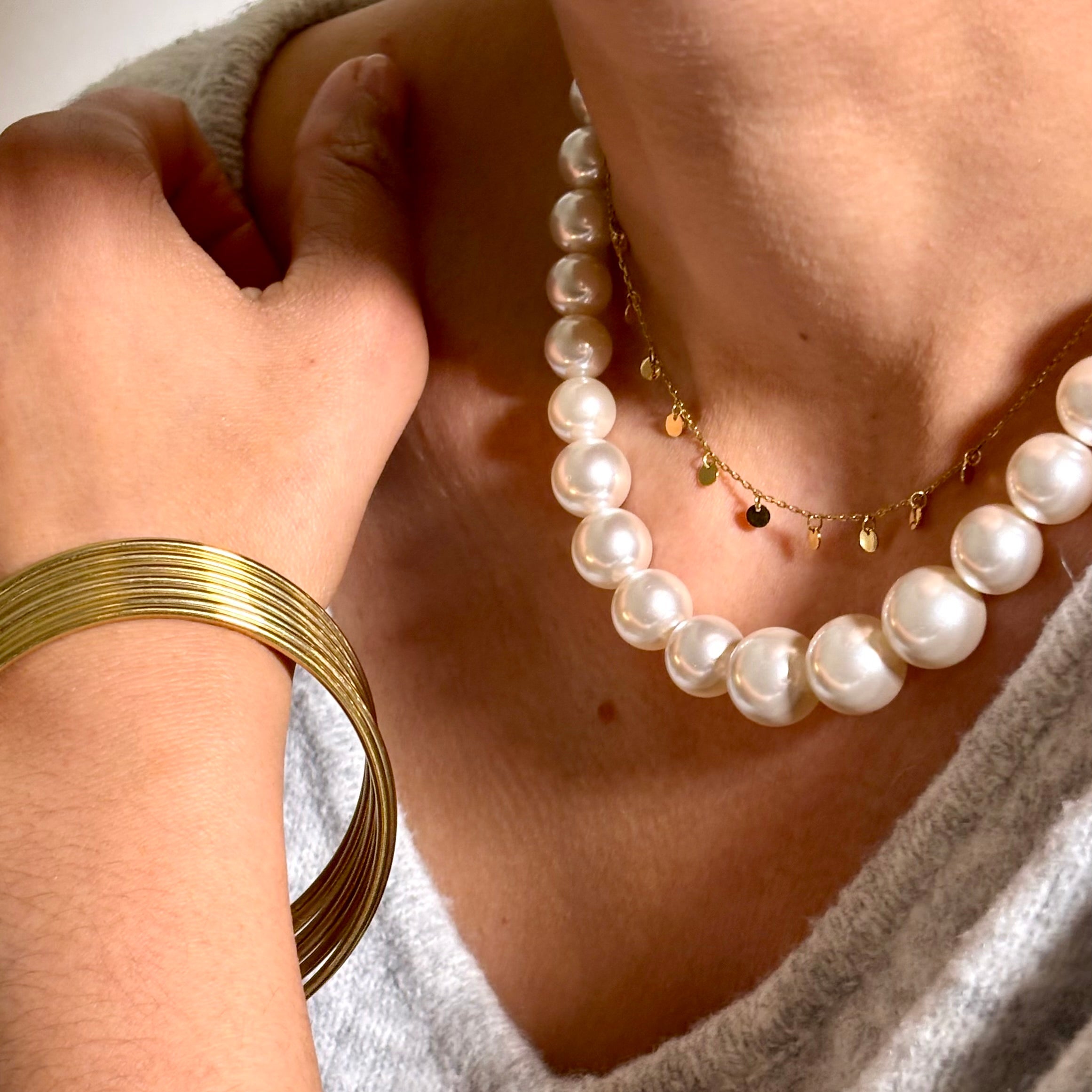 Collier grosses perles en resine blanche porté au cou avec collier petites confettis en acier doré Djanet Bijoux